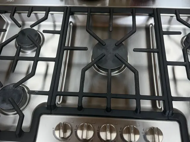 Spotless stainless-steel gas cooktop and grates after a deep clean by Luxurious Cleaning Services LLC
