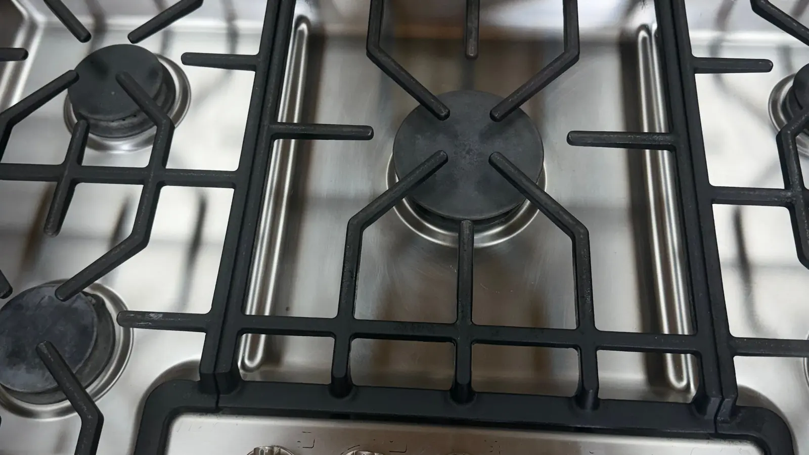 Spotless stainless-steel gas cooktop and grates after a deep clean by Luxurious Cleaning Services LLC